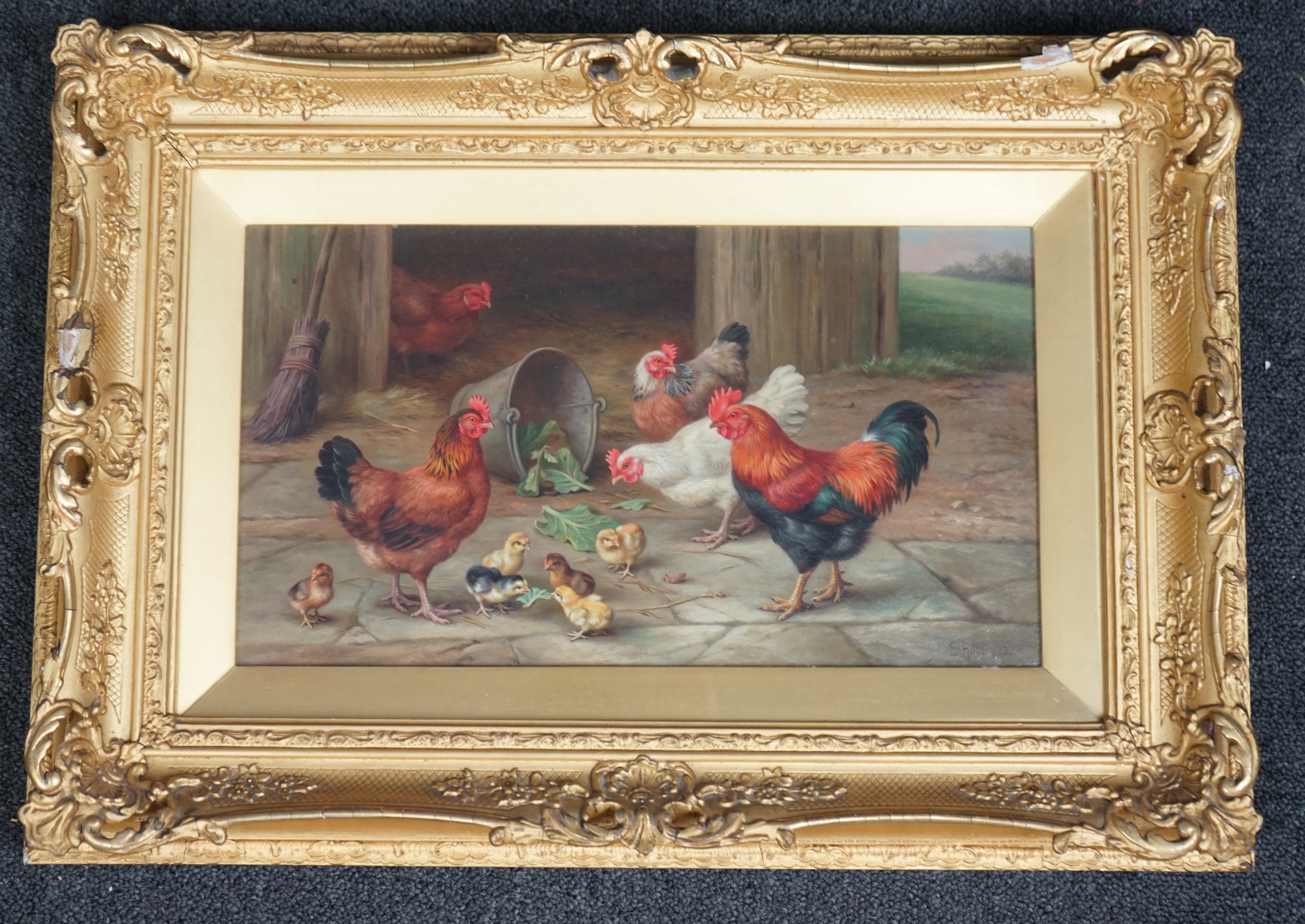Edgar Hunt (English, 1876-1953), Chickens and chicks in a farmyard, oil on canvas, 19 x 34cm